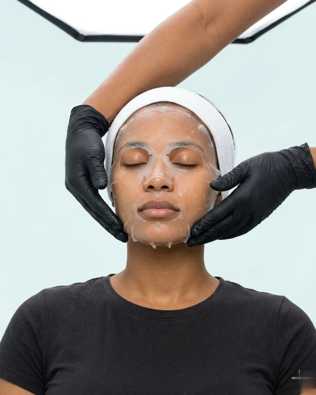 KiWest Spa esthetician applying hyaluronic acid serum during a hydrating facial in Belleville, Barbados